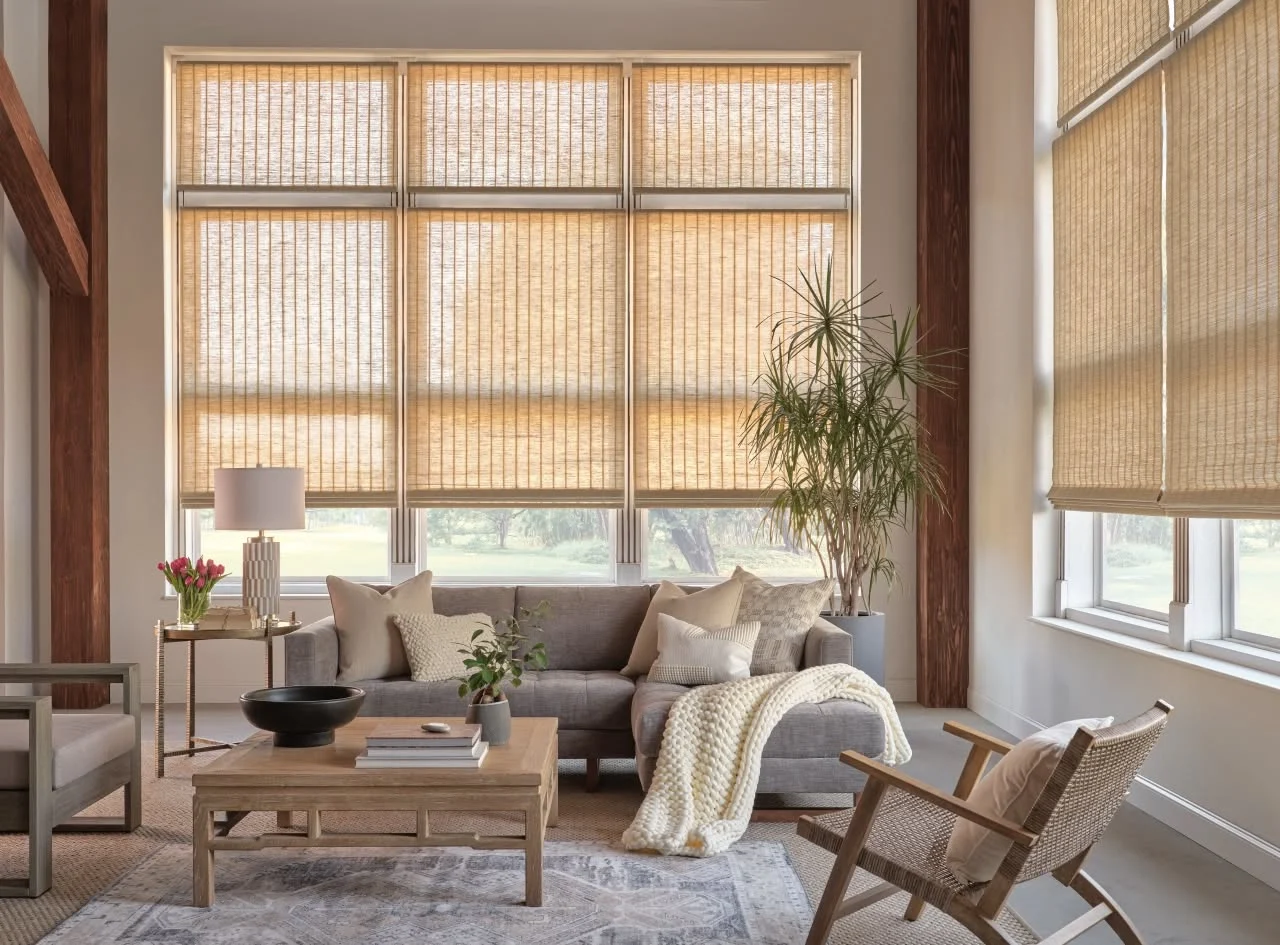 Woven wood shades on tall living room windows, available from Window Coverings by Julie